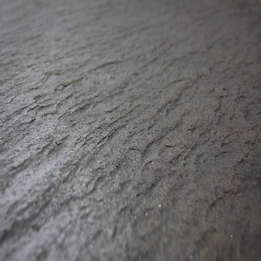 Wall-mounted towel warmer in natural sea rock, programmable with remote control